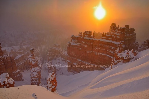 Hoodoos with winter snow and ice fog at dawn, from Sunset Point, Bryce Canyon National Park, Utah, USA
