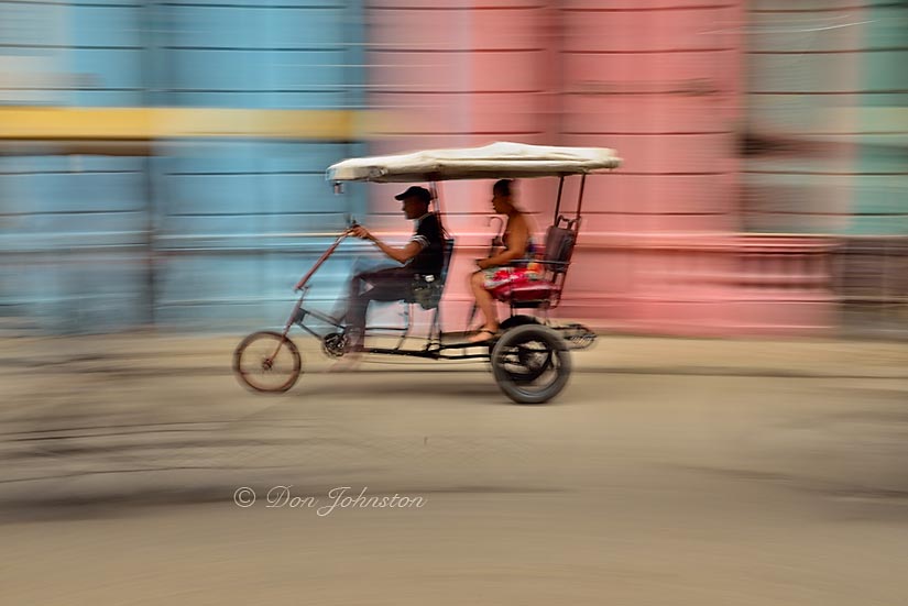 Bicycle taxi and colourful building, panning with camera. ½ s@f16 ISO 100